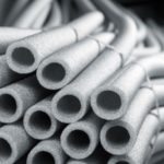 Insulated plumbing pipes stacked to prevent freezing, relevant for winter plumbing maintenance tips.