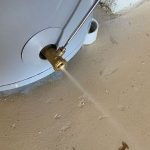 Water heater with a leaking valve, demonstrating the importance of regular maintenance to prevent catastrophic failure and ensure efficiency.